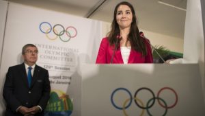 Sarah Walker speaks at the IOC session as IOC President Thomas Bach looks on.
